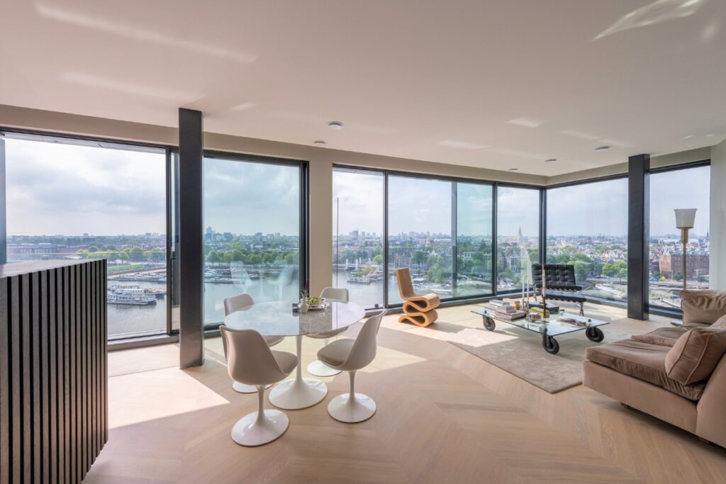 Interior space with Solarlux Cero aluminium sliding doors overlooking a river — designed for maximum light and seamless indoor-outdoor living.