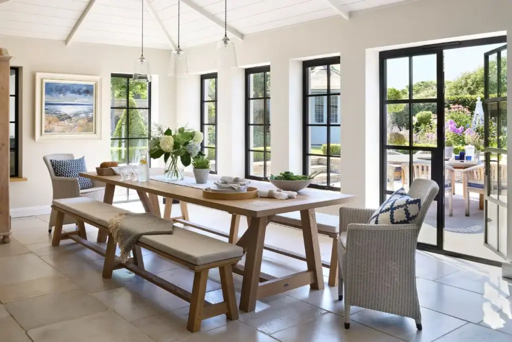 Bright dining room featuring Aluco steel-look aluminium windows and glazed doors