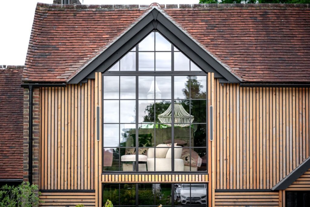 Aluco steel-look aluminium windows Buckinghamshire installed in a gable extension with timber cladding