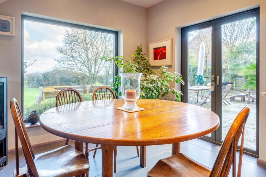 Dining area with fixed picture window and French doors opening to the terrace