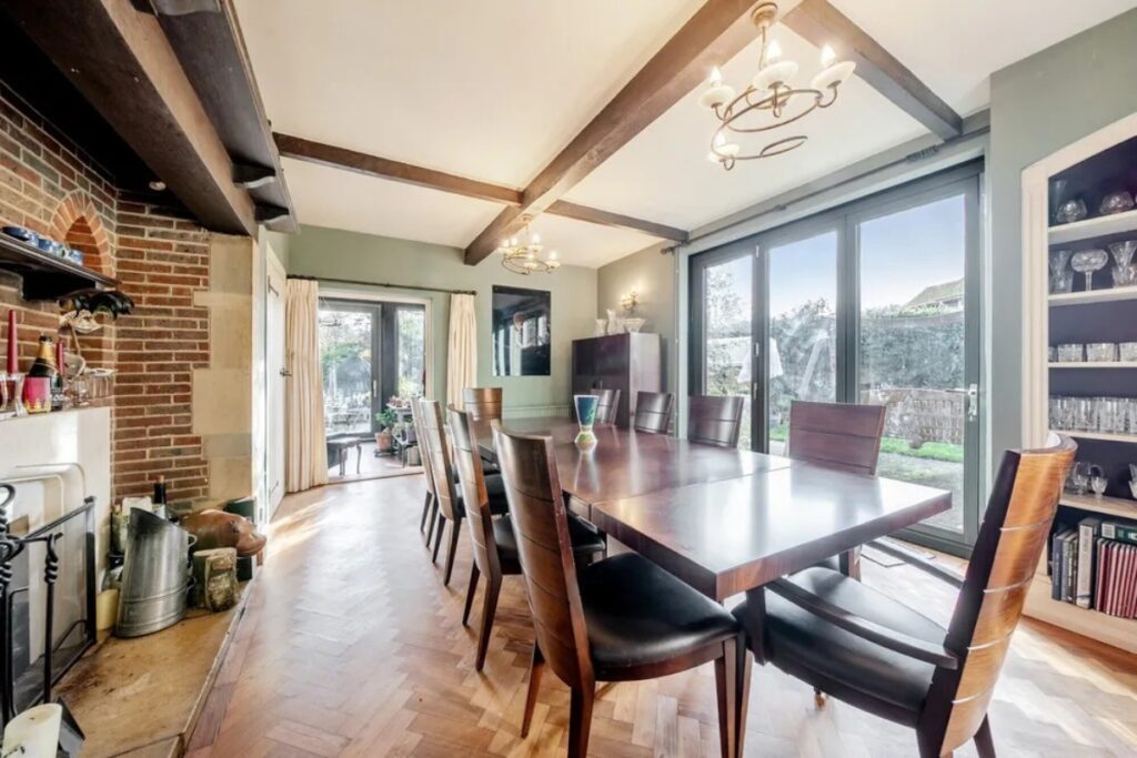 Home office with dual aspect picture windows and slim aluminium frames in a Chilterns property