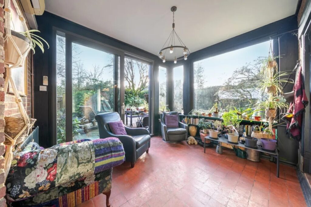 Garden room with slim-framed sliding doors and corner glazing in a Chilterns home